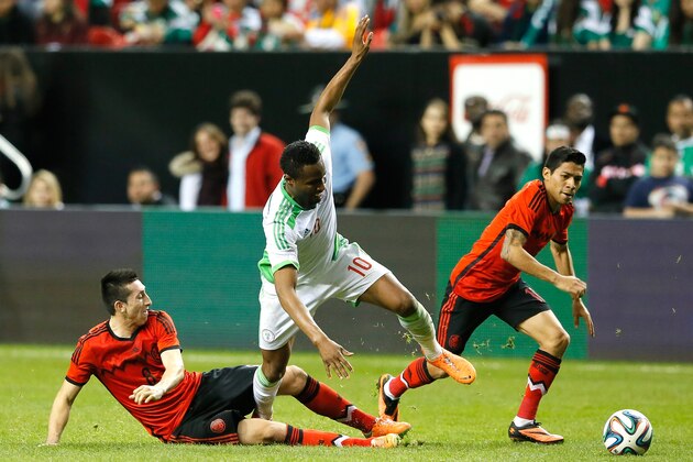 ATLANTA, GA - MARCH 05:  Hector Herrera #8 of Mexico tackles John Obi Mikel #10 of Nigeria against Javier Aquino #11 at Georgia Dome on March 5, 2014 in Atlanta, Georgia.  (Photo by Kevin C. Cox/Getty Images)