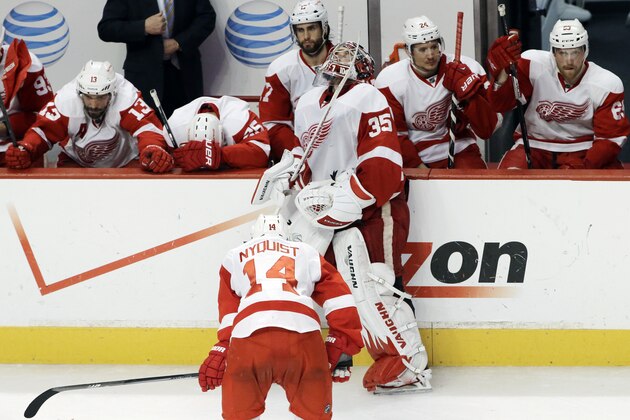 Detroit Red Wings goalie Jimmy Howard (35) and teammates react after the Blackhawks defeated the Red Wings 2-1 in the overtime in Game 7 of the NHL hockey Stanley Cup Western Conference semifinals, Wednesday, May 29, 2013, in Chicago. (AP Photo/Nam Y. Huh)