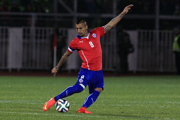 Chile's Arturo Vidal, strike the ball during an international friendly soccer match against against Northern Ireland, in Valparaiso, Chile, Wednesday, June 4, 2014. (AP Photo/Luis Hidalgo)