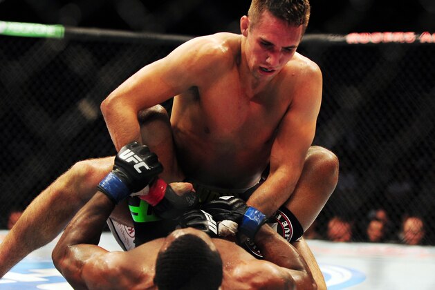 Jun 14, 2014; Vancouver, British Columbia, Canada; Rory MacDonald (red) fights against Tyron Woodley (blue) in their welterweight bout at UFC 174 at Rogers Arena. Mandatory Credit: Anne-Marie Sorvin-USA TODAY Sports