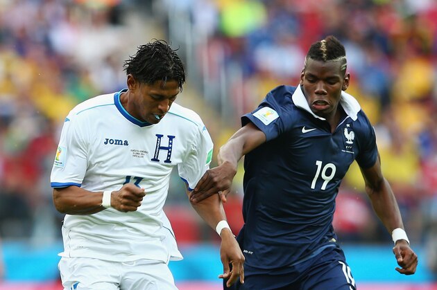 PORTO ALEGRE, BRAZIL - JUNE 15:  Carlo Costly of Honduras controls the ball against Paul Pogba of France during the 2014 FIFA World Cup Brazil Group E match between France and Honduras at Estadio Beira-Rio on June 15, 2014 in Porto Alegre, Brazil.  (Photo by Quinn Rooney/Getty Images)