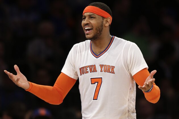 New York Knicks' Carmelo Anthony talks with New York Knicks' head coach Mike Woodson during the second half of the NBA basketball game against the Cleveland Cavaliers at Madison Square Garden, Sunday, March 23, 2014, in New York. The Cavaliers defeated the Knicks 106 to 100. (AP Photo/Seth Wenig)