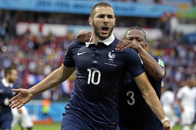 France's Karim Benzema celebrates with teammate France's Patrice Evra after scoring his side's first goal on a penalty kick during the group E World Cup soccer match between France and Honduras at the Estadio Beira-Rio in Porto Alegre, Brazil, Sunday, June 15, 2014.  (AP Photo/Fernando Vergara)