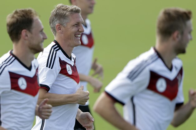 German national soccer player Bastian Schweinsteiger, center, laughs during a training session in Santo Andre near Porto Seguro, Brazil, Saturday, June 14, 2014. Germany will play in group G of the 2014 soccer World Cup. (AP Photo/Matthias Schrader)