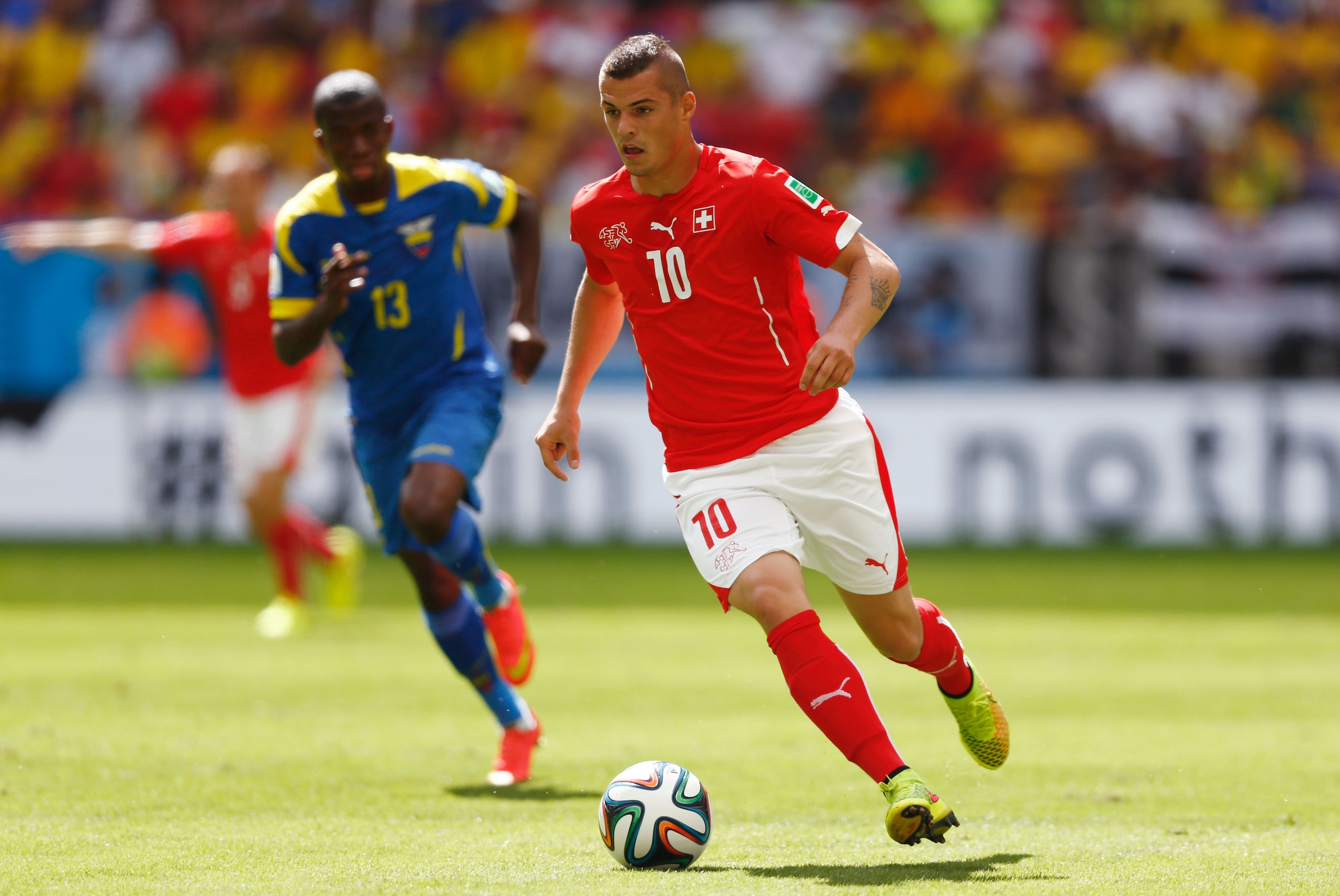 BRASILIA, BRAZIL - JUNE 15:  Granit Xhaka of Switzerland dribbles past Enner Valencia of Ecuador during the 2014 FIFA World Cup Brazil Group E match between Switzerland and Ecuador at Estadio Nacional on June 15, 2014 in Brasilia, Brazil.  (Photo by Phil Walter/Getty Images)