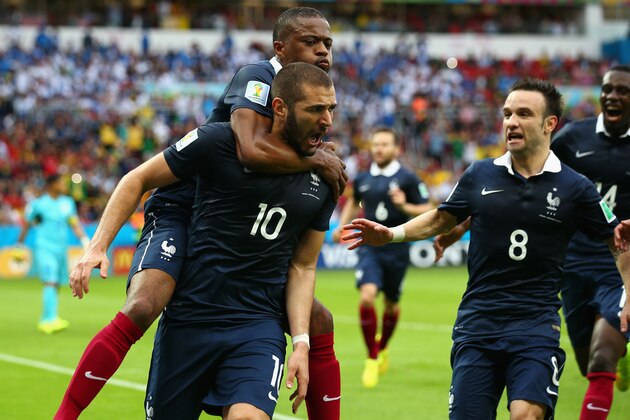 PORTO ALEGRE, BRAZIL - JUNE 15:  Karim Benzema of France celebrates scoring the first goal with Patrice Evra, Mathieu Valbuena during the 2014 FIFA World Cup Brazil Group E match between France and Honduras at Estadio Beira-Rio on June 15, 2014 in Porto Alegre, Brazil.  (Photo by Ian Walton/Getty Images)