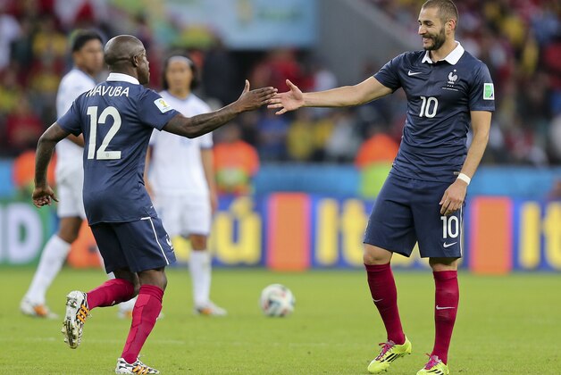 France's Karim Benzema, right, celebrates with France's Rio Mavuba after scoring his side's third goal during the group E World Cup soccer match between France and Honduras at the Estadio Beira-Rio in Porto Alegre, Brazil, Sunday, June 15, 2014. (AP Photo/David Vincent)
