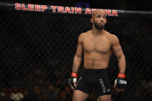 December 14, 2013; Sacramento, CA, USA; Demetrious Johnson (red gloves) fights Joseph Benavidez (blue gloves) during the flyweight championship bout of the UFC on FOX 9 at Sleep Train Arena. Johnson defeated Benavidez. Mandatory Credit: Kyle Terada-USA TODAY Sports