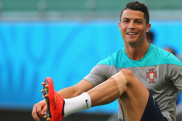 SALVADOR, BRAZIL - JUNE 15: Cristiano Ronaldo stretchs  during the Portugal training session ahead of the 2014 FIFA World Cup Group G match between Germany and Portugal held at the Arena Fonte Nova on June 15, 2014 in Salvador, Brazil.  (Photo by Martin Rose/Getty Images)