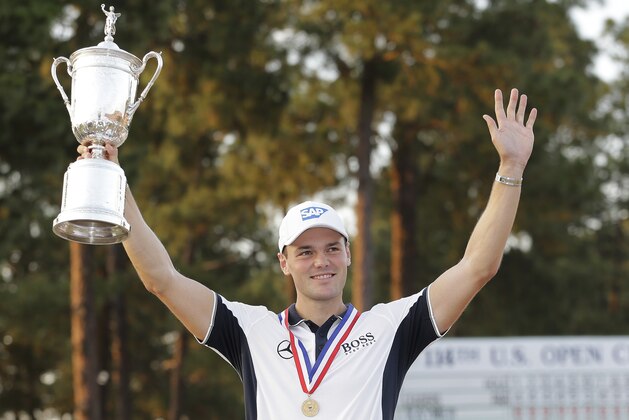 Martin Kaymer, of Germany, holds up the trophy after wining the U.S. Open golf tournament in Pinehurst, N.C., Sunday, June 15, 2014.  (AP Photo/Eric Gay)