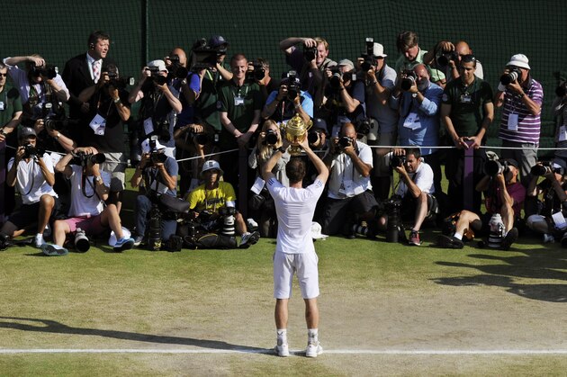 Andy Murray of Britain poses for photographers with the trophy after defeating Novak Djokovic of Serbia in the Men's singles final match at the All England Lawn Tennis Championships in Wimbledon, London, Sunday, July 7, 2013. (AP Photo/Tom Hevezi, Pool)