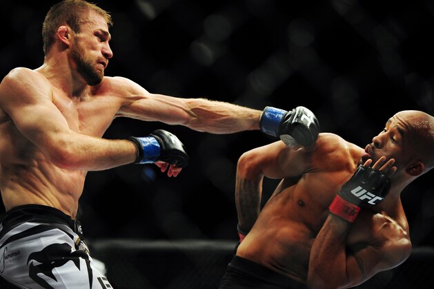 Jun 14, 2014; Vancouver, British Columbia, Canada; Demetrious Johnson (red) fights against Ali Bagautinov (blue) in the flyweight title bout at UFC 174 at Rogers Arena. Mandatory Credit: Anne-Marie Sorvin-USA TODAY Sports