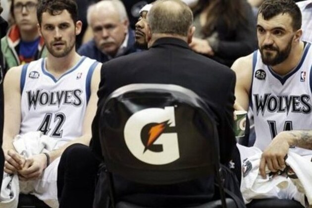 Minnesota Timberwolves' Kevin Love, left, and Nikola Pekovic listen as coach Rick Adelman speaks during a second-half timeout during the Timberwolves' 111-108 loss to the Sacramento Kings in an NBA basketball game, Wednesday, Jan. 15, 2014, in Minneapolis. (AP Photo/Jim Mone)