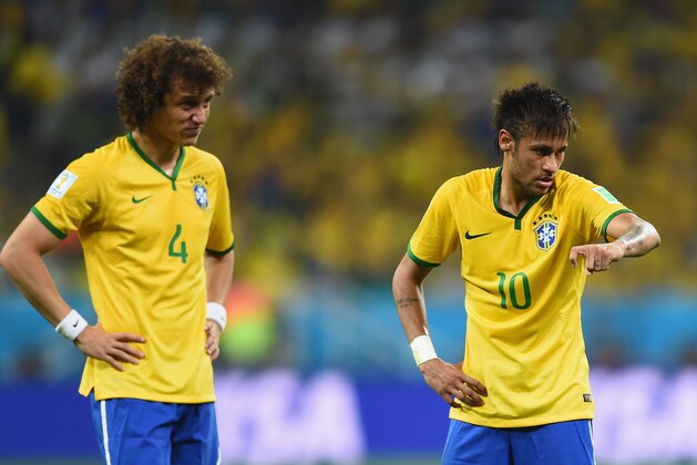 SAO PAULO, BRAZIL - JUNE 12:  David Luiz and Neymar of Brazil look on during the 2014 FIFA World Cup Brazil Group A match between Brazil and Croatia at Arena de Sao Paulo on June 12, 2014 in Sao Paulo, Brazil.  (Photo by Buda Mendes/Getty Images)