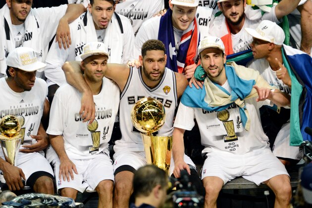 SAN ANTONIO, TX - JUNE 15: Kawhi Leonard #2, Tony Parker #9, Tim Duncan #21, Manu Ginobili #20, and Patty Mills #8 of the San Antonio Spurs celebrate with the Larry O'Brien trophy after defeating the Miami Heat to win the 2014 NBA Finals in Game Five of the 2014 NBA Finals on June 15, 2014 at AT&T Center in San Antonio, Texas. NOTE TO USER: User expressly acknowledges and agrees that, by downloading and or using this photograph, User is consenting to the terms and conditions of the Getty Images License Agreement. Mandatory Copyright Notice: Copyright 2014 NBAE (Photo by Jesse D. Garrabrant/NBAE via Getty Images)
