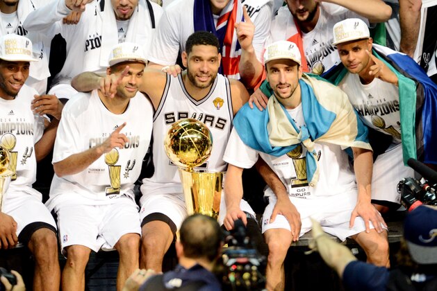 SAN ANTONIO, TX - JUNE 15: Kawhi Leonard #2, Tony Parker #9, Tim Duncan #21, Manu Ginobili #20, and Patty Mills #8 of the San Antonio Spurs celebrate with the Larry O'Brien trophy after defeating the Miami Heat to win the 2014 NBA Finals in Game Five of the 2014 NBA Finals on June 15, 2014 at AT&T Center in San Antonio, Texas. NOTE TO USER: User expressly acknowledges and agrees that, by downloading and or using this photograph, User is consenting to the terms and conditions of the Getty Images License Agreement. Mandatory Copyright Notice: Copyright 2014 NBAE (Photo by Jesse D. Garrabrant/NBAE via Getty Images)