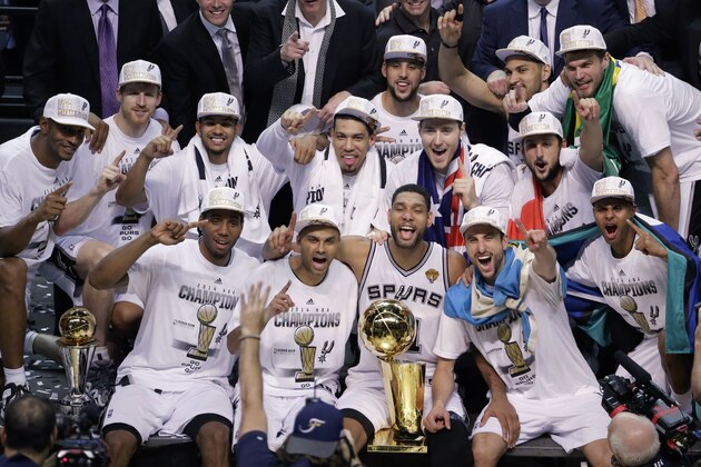 The San Antonio Spurs pose for a photo after Game 5 of the NBA basketball finals against the Miami Heat on Sunday, June 15, 2014, in San Antonio. The Spurs won the NBA championship 104-87. (AP Photo/Tony Gutierrez)