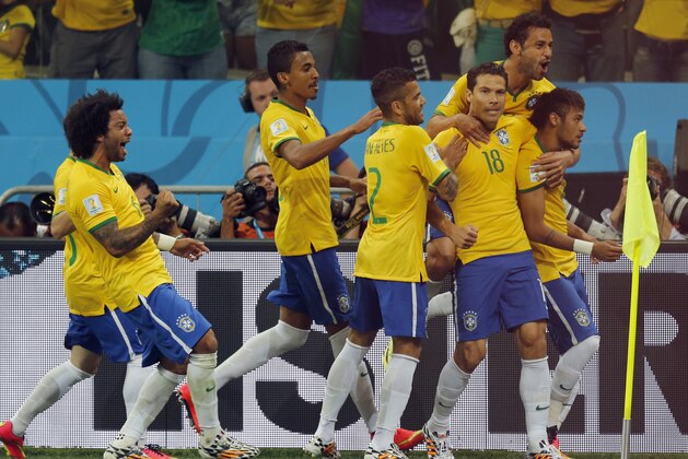 Brazil players celebrate after Neymar, right, scored a penalty kick during the group A World Cup soccer match between Brazil and Croatia, the opening game of the tournament, in the Itaquerao Stadium in Sao Paulo, Brazil, Thursday, June 12, 2014.  (AP Photo/Frank Augstein)