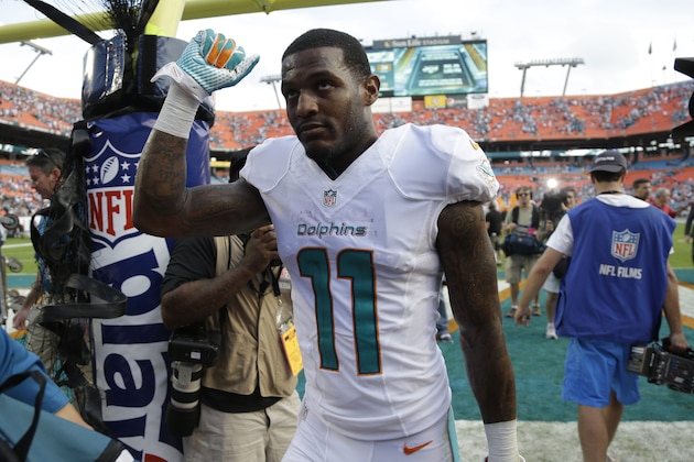 Miami Dolphins wide receiver Mike Wallace (11) walks off the field after the Dolphins defeated the New England Patriots 24-20 in an NFL football game, Sunday, Dec. 15, 2013, in Miami Gardens, Fla. (AP Photo/Lynne Sladky)