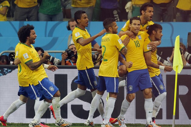 Brazil players celebrate after Neymar, right, scored a penalty kick during the group A World Cup soccer match between Brazil and Croatia, the opening game of the tournament, in the Itaquerao Stadium in Sao Paulo, Brazil, Thursday, June 12, 2014.  (AP Photo/Frank Augstein)