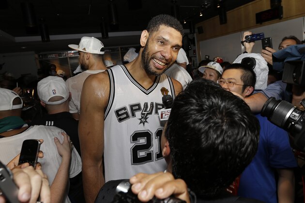 San Antonio Spurs forward Tim Duncan (21) smiles while celebrating in the locker room after Game 5 of the NBA basketball finals against the Miami Heat on Sunday, June 15, 2014, in San Antonio. The Spurs won the NBA championship 104-87. (AP Photo/David J. Phillip)
