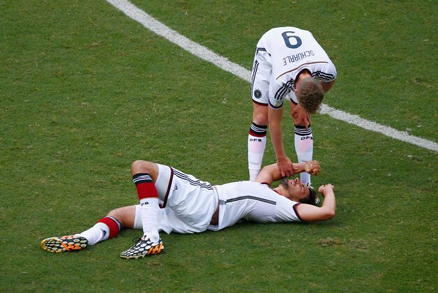 SALVADOR, BRAZIL - JUNE 16: Andre Schuerrle of Germany stands over injured teammate Mats Hummels during the 2014 FIFA World Cup Brazil Group G match between Germany and Portugal at Arena Fonte Nova on June 16, 2014 in Salvador, Brazil.  (Photo by Matthew Lewis/Getty Images)