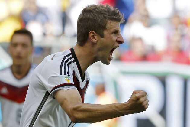 Germany's Thomas Mueller celebrates after scoring the opening goal during the group G World Cup soccer match between Germany and Portugal at the Arena Fonte Nova in Salvador, Brazil, Monday, June 16, 2014.  (AP Photo/Matthias Schrader)
