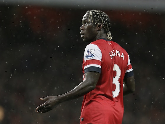 Arsenal's Bacary Sagna gestures to a teammate as he plays against Wigan Athletic during their English Premier League soccer match at Arsenal's Emirates stadium in London, Tuesday, May  14, 2013. (AP Photo/Alastair Grant)
