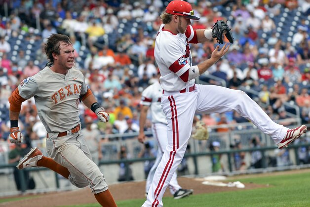 Texas' Ben Johnson, left, can't beat the throw from Louisville shortstop Sutton Whiting to first baseman Grant Kay, right, and is out at first base in the fifth inning of an NCAA baseball College World Series elimination game in Omaha, Neb., Monday, June 16, 2014. (AP Photo/Ted Kirk)