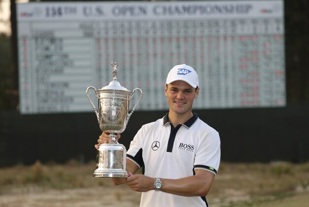 Martin Kaymer, of Germany, poses with trophy after wining the U.S. Open golf tournament in Pinehurst, N.C., Sunday, June 15, 2014.  (AP Photo/Eric Gay)