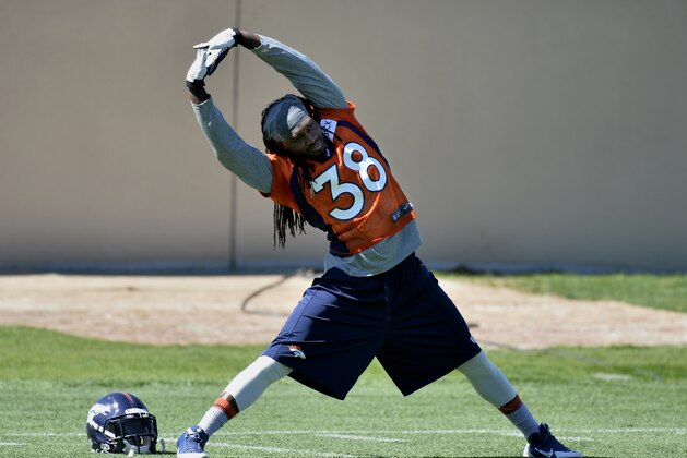 Denver Broncos' Quinton Carter stretches  during an NFL football organized team activity, Wednesday, May 28, 2014, in Englewood, Colo. (AP Photo/Jack Dempsey)