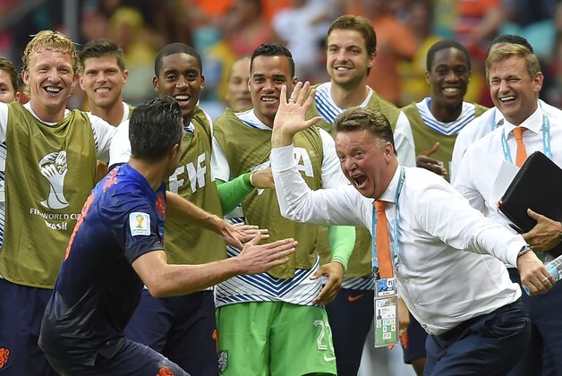 Netherlands' Robin van Persie celebrates with Netherlands' head coach Louis van Gaal after scoring a goal during the group B World Cup soccer match between Spain and the Netherlands at the Arena Ponte Nova in Salvador, Brazil, Friday, June 13, 2014. (AP Photo/Manu Fernandez)