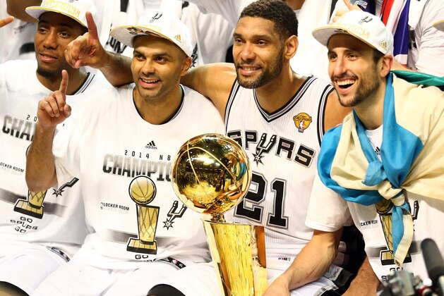 SAN ANTONIO, TX - JUNE 15:  The San Antonio Spurs celebrate with the Larry O'Brien trophy after defeating the Miami Heat to win the 2014 NBA Finals at the AT&T Center on June 15, 2014 in San Antonio, Texas. NOTE TO USER: User expressly acknowledges and agrees that, by downloading and or using this photograph, User is consenting to the terms and conditions of the Getty Images License Agreement.  (Photo by Andy Lyons/Getty Images)