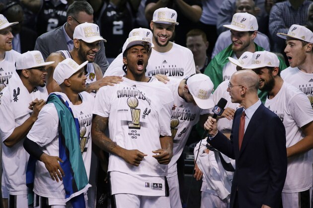 Most Valuable Player San Antonio Spurs forward Kawhi Leonard, center celebrates with the team after Game 5 of the NBA basketball finals against the Miami Heat on Sunday, June 15, 2014, in San Antonio. The Spurs won the NBA championship 104-87. (AP Photo/Tony Gutierrez)