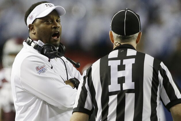 Texas A&M head coach Kevin Sumlin talks with a referee in the first half of the Chick-fil-A Bowl NCAA college football game against Duke Tuesday, Dec. 31, 2013, in Atlanta. (AP Photo/John Bazemore)