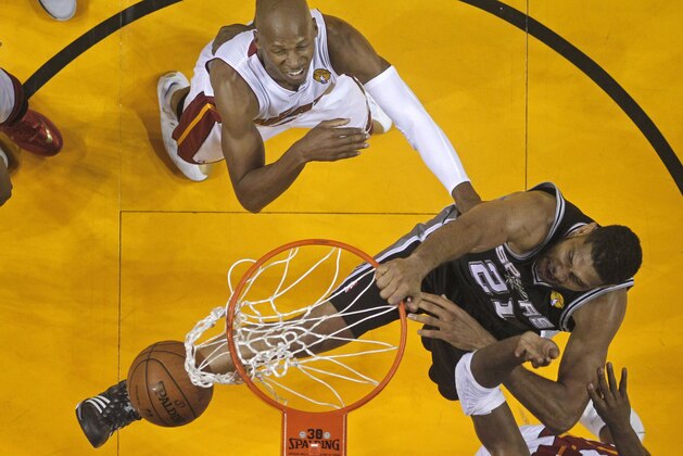 San Antonio Spurs forward Tim Duncan (21) dunks as Miami Heat guard Ray Allen (34) defends in the second half in Game 4 of the NBA basketball finals, early Friday, June 13, 2014, in Miami. The Spurs won 107-86. (AP Photo/Lynne Sladky)