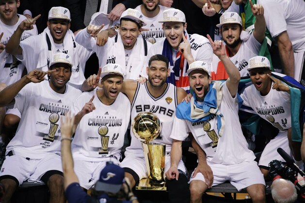 The San Antonio Spurs pose for a photo after Game 5 of the NBA basketball finals against the Miami Heat on Sunday, June 15, 2014, in San Antonio. The Spurs won the NBA championship 104-87. (AP Photo/Tony Gutierrez)