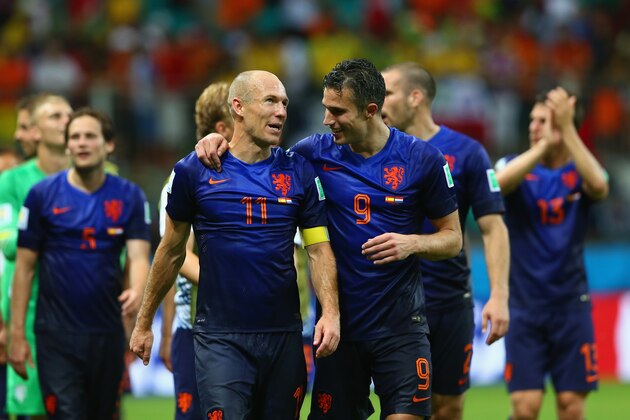 SALVADOR, BRAZIL - JUNE 13: Arjen Robben (L) and Robin van Persie of the Netherlands walk off the field after scoring two goals each and defeating Spain 5-1 during the 2014 FIFA World Cup Brazil Group B match between Spain and Netherlands at Arena Fonte Nova on June 13, 2014 in Salvador, Brazil.  (Photo by Quinn Rooney/Getty Images)