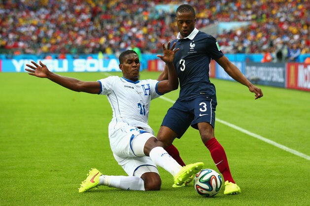 PORTO ALEGRE, BRAZIL - JUNE 15: Brayan Beckeles of Honduras challenges Patrice Evra of France during the 2014 FIFA World Cup Brazil Group E match between France and Honduras at Estadio Beira-Rio on June 15, 2014 in Porto Alegre, Brazil. (Photo by Ian Walton/Getty Images) PORTO ALEGRE, BRAZIL - JUNE 15: Brayan Beckeles of Honduras challenges Patrice Evra of France during the 2014 FIFA World Cup Brazil Group E match between France and Honduras at Estadio Beira-Rio on June 15, 2014 in Porto Alegre, Brazil. (Photo by Ian Walton/Getty Images)
