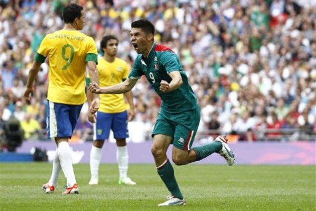Mexico's Oribe Peralta, right, celebrates in front of Brazil's Leandro Damiao, left, during the men's soccer final at the 2012 Summer Olympics, Saturday, Aug. 11, 2012, in London. (AP Photo/Jon Super)