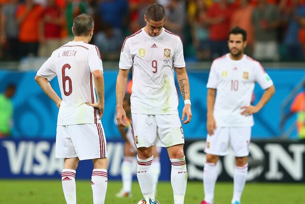 SALVADOR, BRAZIL - JUNE 13:  (L - R) Andres Iniesta; Fernando Torres and Cesc Fabregas of Spain look dejected pduring the 2014 FIFA World Cup Brazil Group B match between Spain and Netherlands at Arena Fonte Nova on June 13, 2014 in Salvador, Brazil.  (Photo by Quinn Rooney/Getty Images)