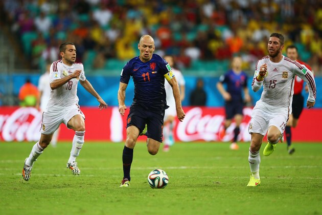 SALVADOR, BRAZIL - JUNE 13:  Arjen Robben of the Netherlands beats Sergio Ramos and Jordi Alba during the 2014 FIFA World Cup Brazil Group B match between Spain and Netherlands at Arena Fonte Nova on June 13, 2014 in Salvador, Brazil.  (Photo by Paul Gilham/Getty Images)