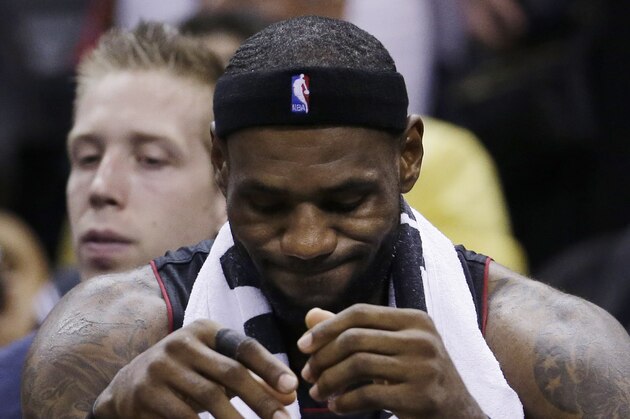 Miami Heat forward LeBron James sits on the bench during the second half in Game 5 of the NBA basketball finals against the San Antonio Spurs on Sunday, June 15, 2014, in San Antonio. The Spurs won the NBA championship 104-87. (David J. Phillip)