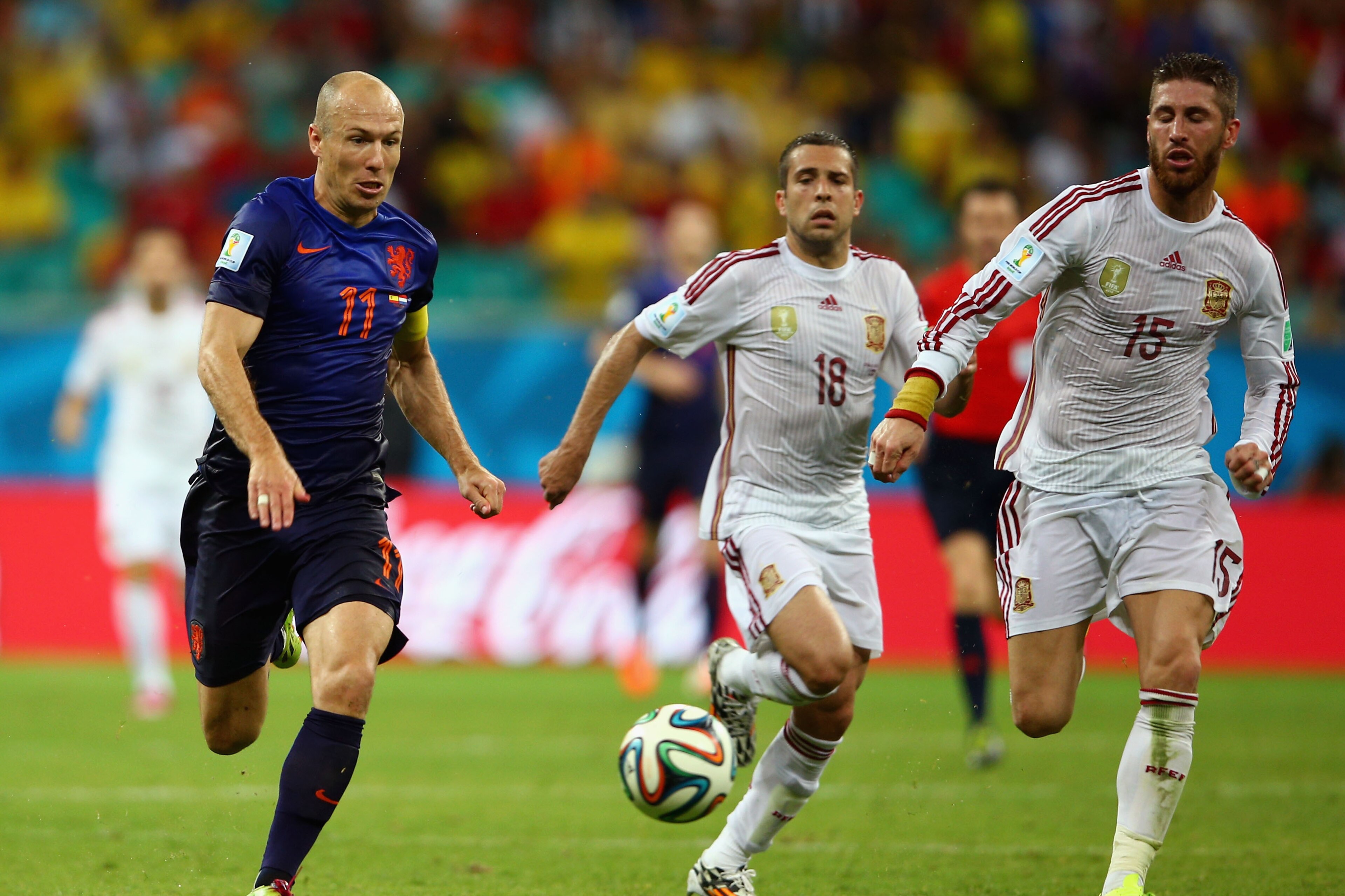 SALVADOR, BRAZIL - JUNE 13:  Arjen Robben of the Netherlands beats Sergio Ramos and Jordi Alba during the 2014 FIFA World Cup Brazil Group B match between Spain and Netherlands at Arena Fonte Nova on June 13, 2014 in Salvador, Brazil.  (Photo by Paul Gilham/Getty Images)