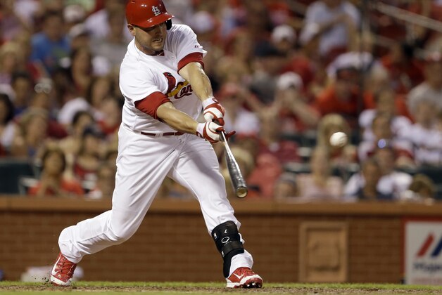 St. Louis Cardinals' Matt Holliday hits an RBI single, the 1000th RBI of his career, to score Jon Jay during the fifth inning of a baseball game against the New York Mets, Monday, June 16, 2014, in St. Louis. (AP Photo/Jeff Roberson)