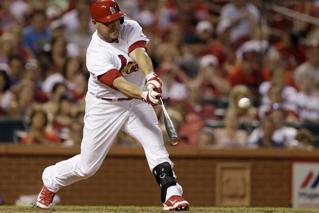 St. Louis Cardinals' Matt Holliday hits an RBI single, the 1000th RBI of his career, to score Jon Jay during the fifth inning of a baseball game against the New York Mets, Monday, June 16, 2014, in St. Louis. (AP Photo/Jeff Roberson)