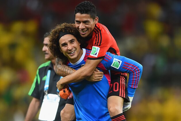 FORTALEZA, BRAZIL - JUNE 17:  Goalkeeper Guillermo Ochoa of Mexico celebrates with Javier Aquino after their 0-0 draw with Brazil during the 2014 FIFA World Cup Brazil Group A match between Brazil and Mexico at Castelao on June 17, 2014 in Fortaleza, Brazil.  (Photo by Laurence Griffiths/Getty Images)