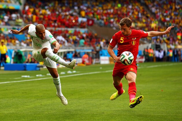 BELO HORIZONTE, BRAZIL - JUNE 17:  Sofiane Feghouli of Algeria shoots against Jan Vertonghen of Belgium during the 2014 FIFA World Cup Brazil Group H match between Belgium and Algeria at Estadio Mineirao on June 17, 2014 in Belo Horizonte, Brazil.  (Photo by Ian Walton/Getty Images)