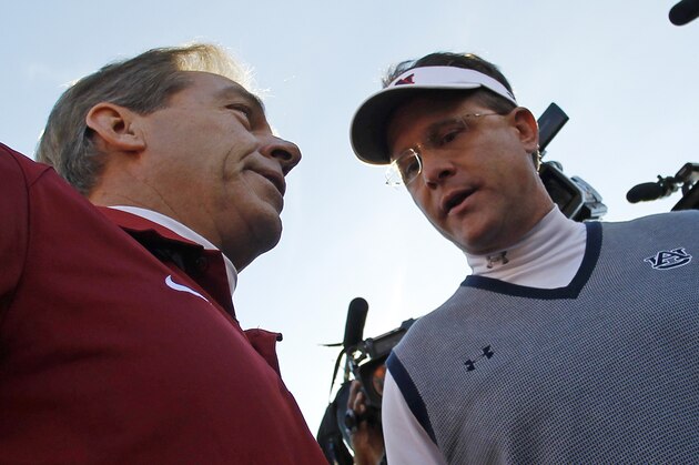 Alabama head coach Nick Saban, left, talks with Auburn head coach Gus Malzahn prior to the start of an NCAA college football game in Auburn, Ala., Saturday, Nov. 30, 2013. (AP Photo/Butch Dill)