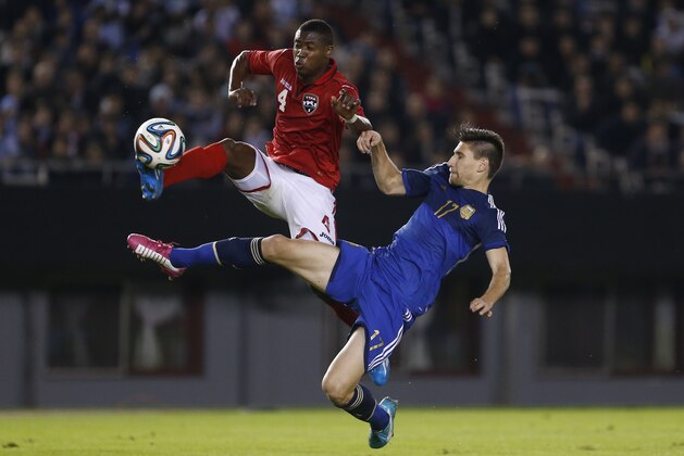 Trinidad and Tobago's Sheldon Bateau, left, and Argentina's Federico Fernandez, right, vie for the ball during their international friendly soccer match in Buenos Aires, Argentina, Wednesday, June 4, 2014. (AP Photo/Victor R. Caivano)